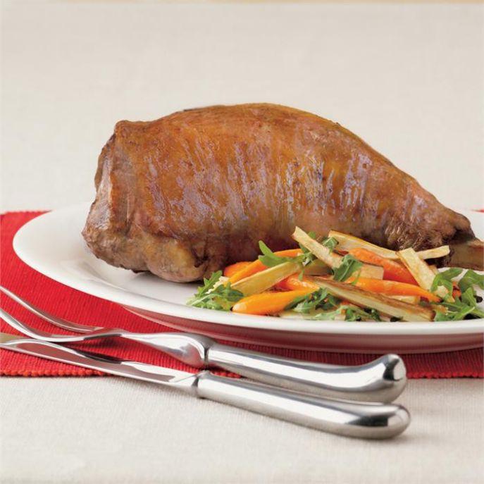Baked leg of lamb with roasted root vegetable and rocket