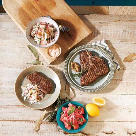 Barbecued t-bone steaks with a watermelon and red onion salad