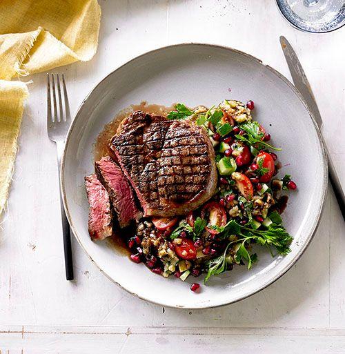 Grilled beef scotch fillet steaks with smoky eggplant and pomegranate salad